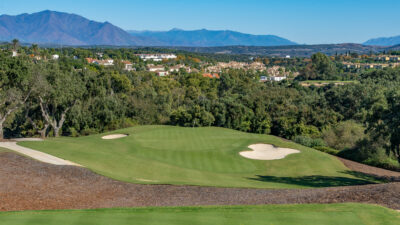 Hole with bunkers with trees around at San Roque - The Old Course