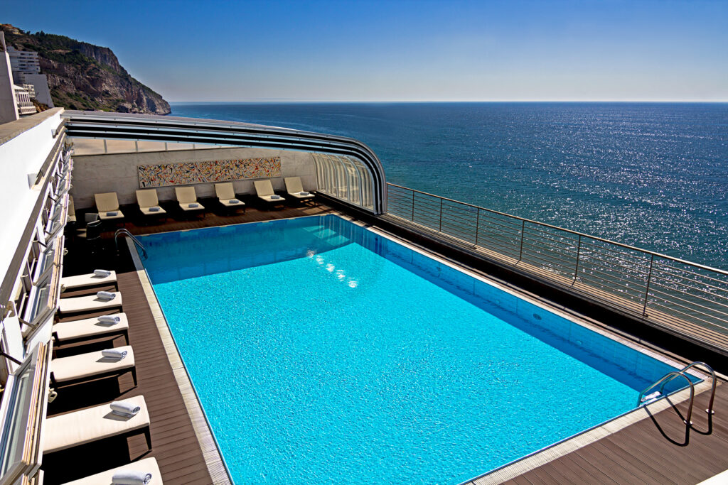 Outdoor pool with ocean view at Sana Sesimbra Hotel