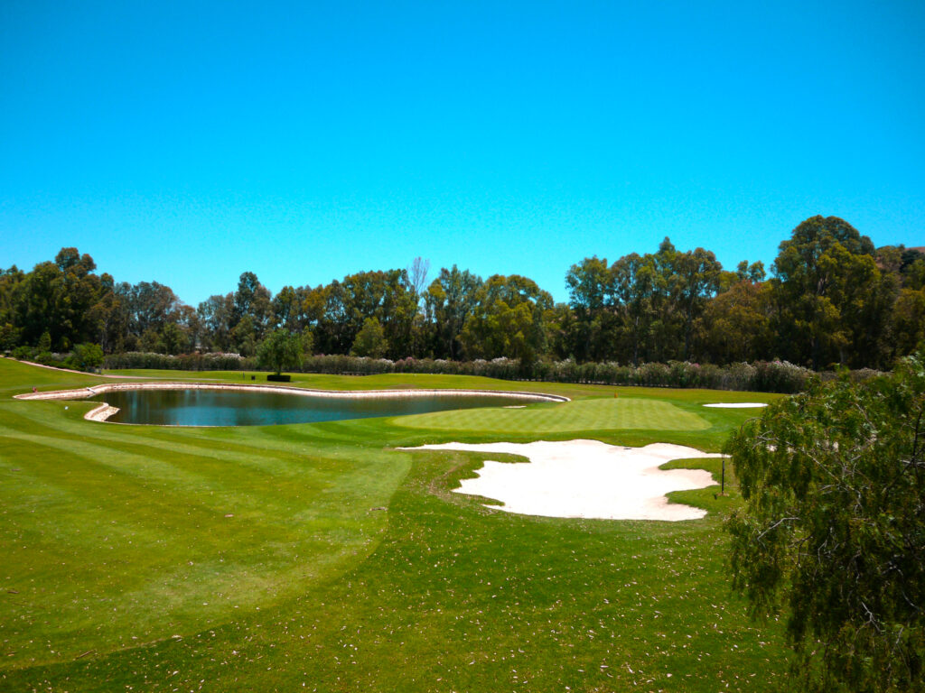 Lake and bunker on fairway at Santana Golf Course with trees around