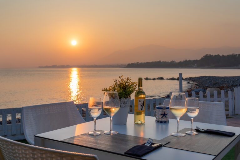 Outdoor dining at sunset with beach view at Sol Marbella Estepona Atalaya Park