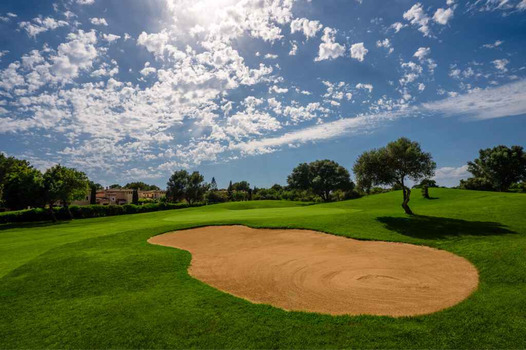 Bunker on fairway with trees around at Son Antem - East Course