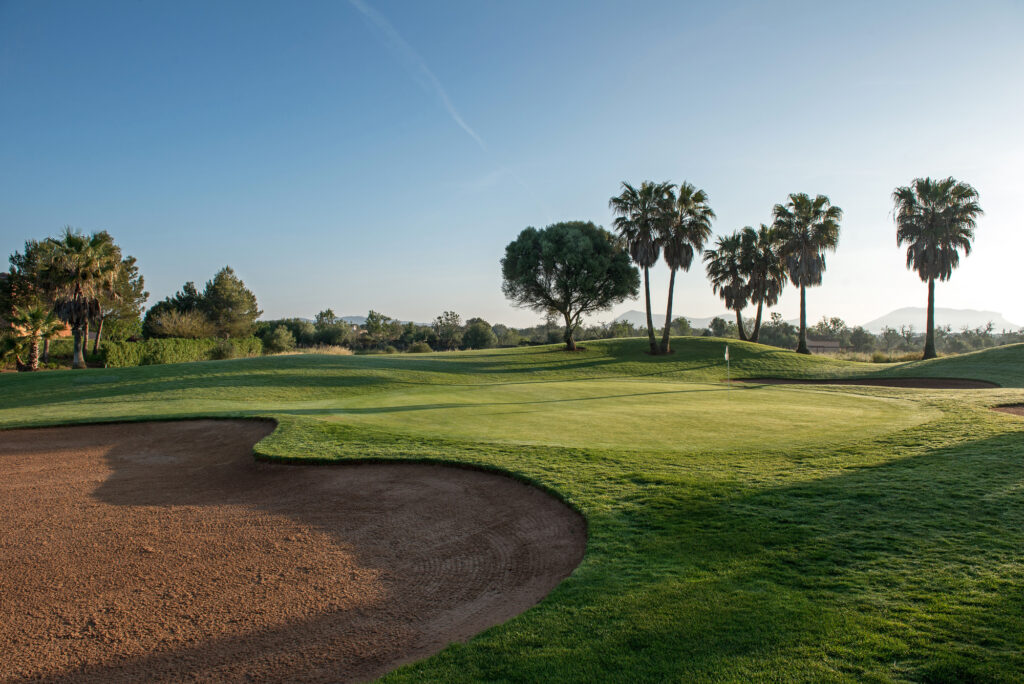 Bunker by hole with trees in background at Son Antem - East Course