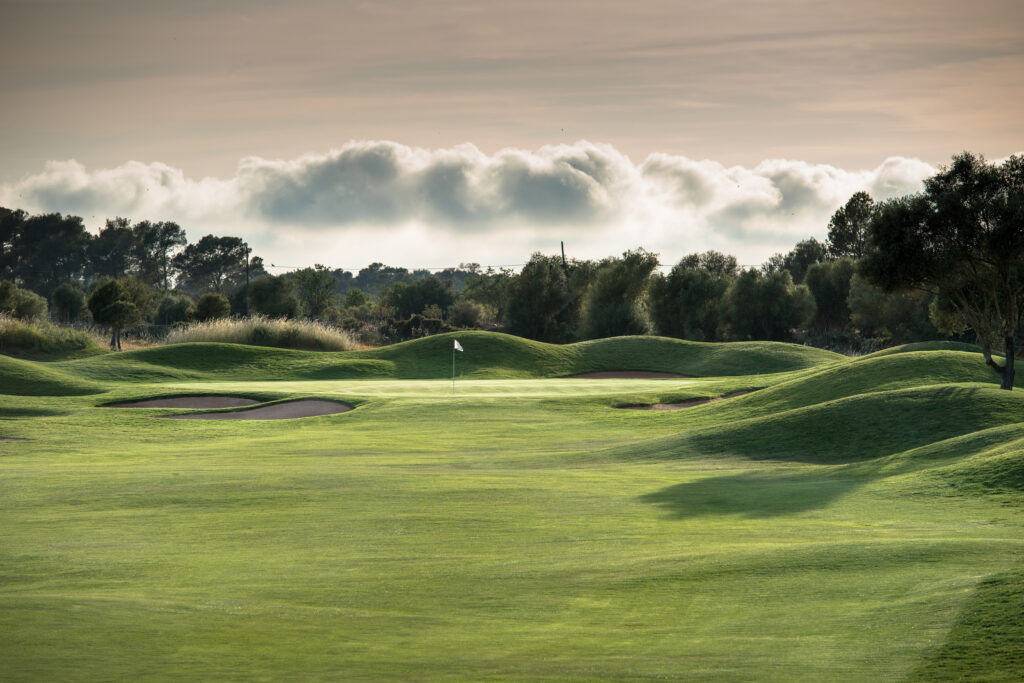 Hole with bunkers and mounds with trees in background at Son Antem - West Course