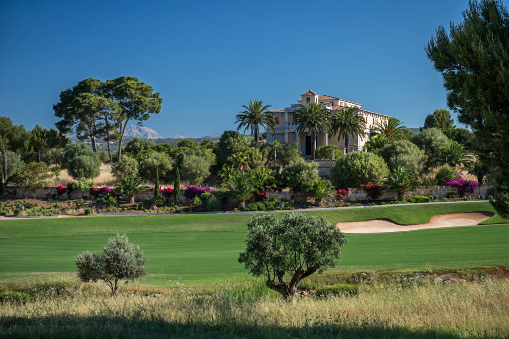 Bunker on fairway with trees around with building in background at Son Gual Golf Course