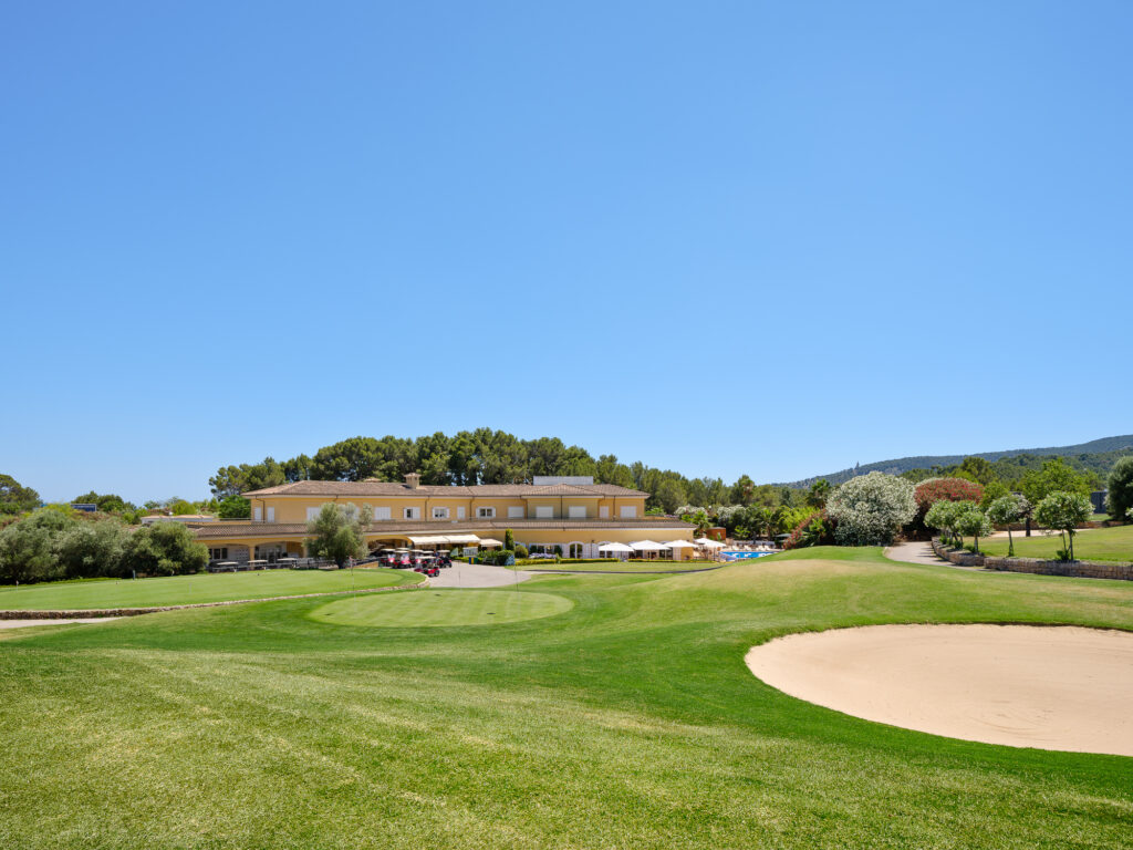 Clubhouse at Son Quint Golf Course with bunkers on fairway