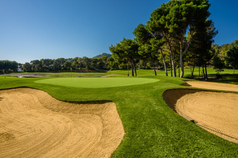 Bunkers near hole at Son Servera Golf Course with trees around