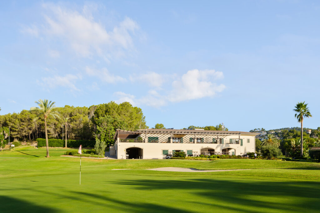 Hole on the Son Vida Golf Course with building and trees in background