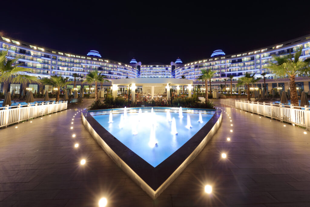 Fountain and view of exterior of Sueno Hotels Deluxe Belek at night