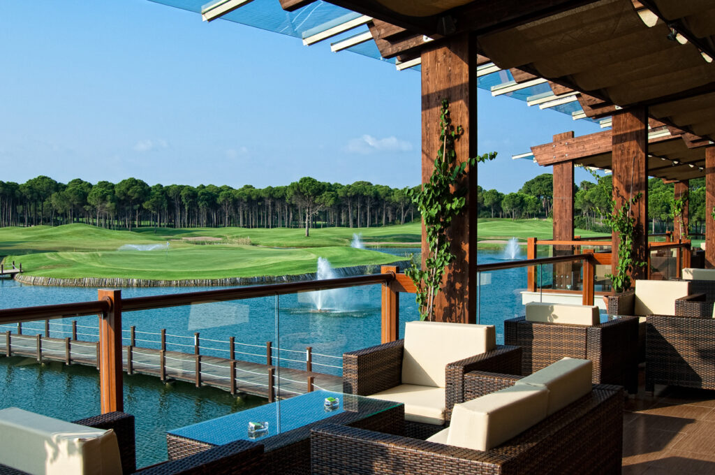 Outdoor seating with lake view at Sueno Hotels Golf Belek