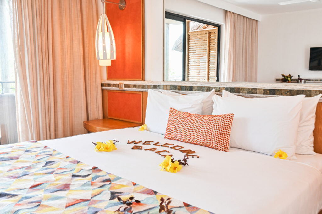 Double bed accommodation at Tamarina Golf & Spa Boutique Hotel with welcome back written on bed