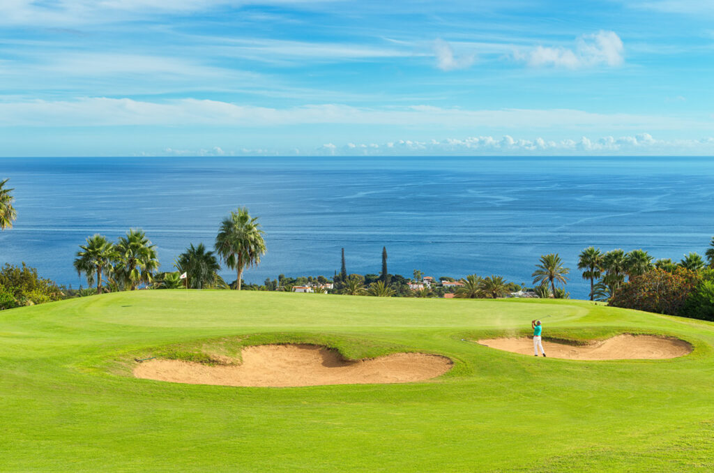 Person playing golf at Tecina Golf with ocean view