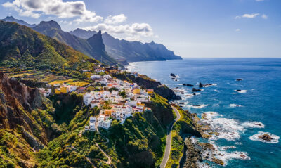 a cliff edge town next to the sea in tenerife