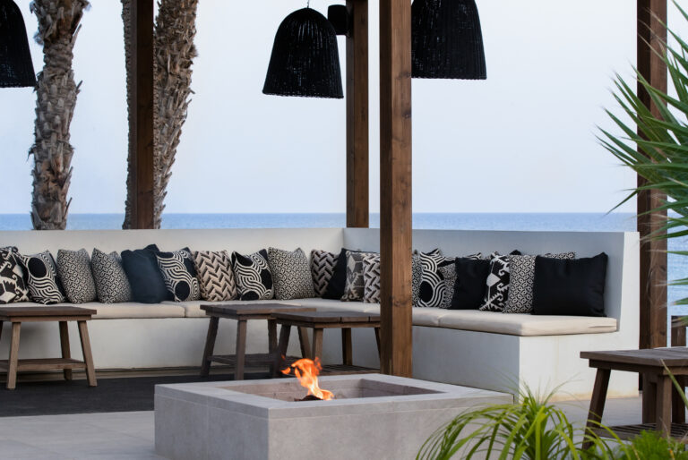 Outdoor seating area with fire pit at Thanos Hotel Almyra