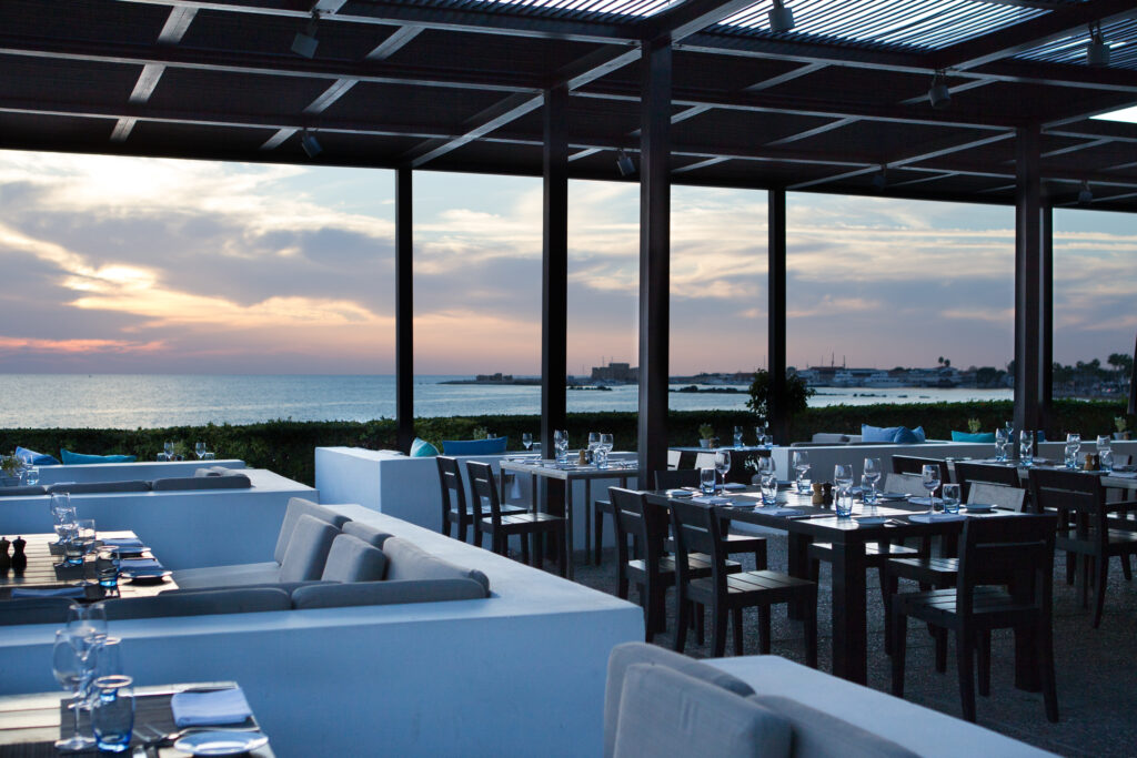 Outdoor dining at Thanos Hotel Almyra with ocean view