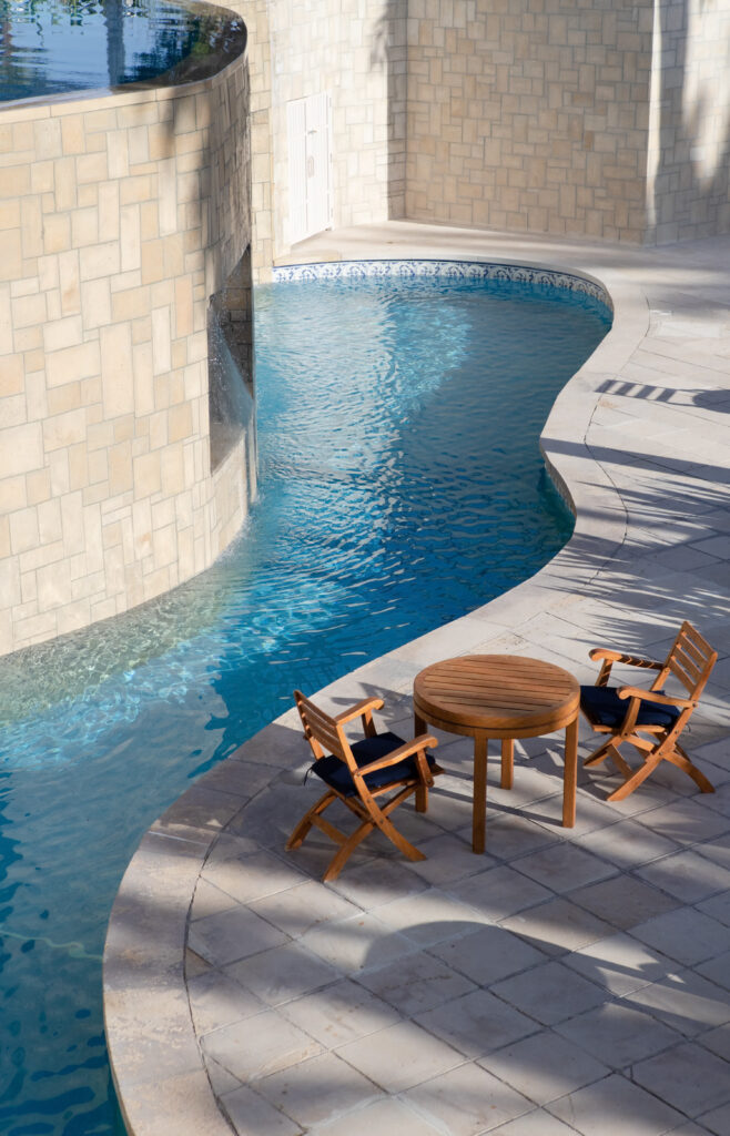 Outdoor pool with table and chairs at Thanos Hotel Annabelle