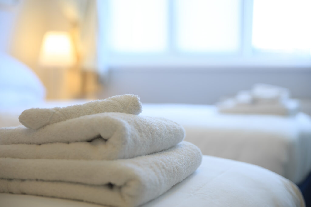 Towels on bed at The Dormy at Royal Porthcawl