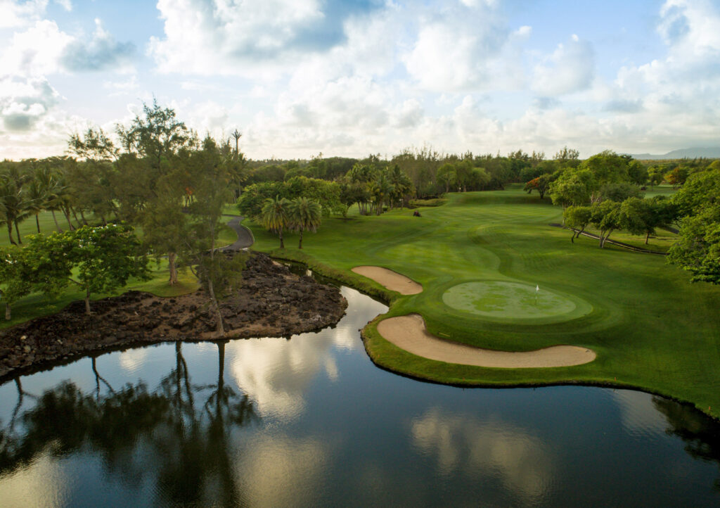 Hole with bunkers and a lake at The Legend Golf Course with trees around