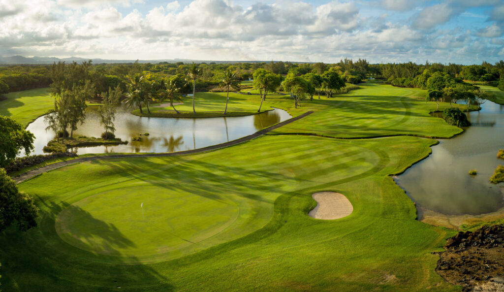 Hole with bunker and lakes at The Legend Golf Course with trees around