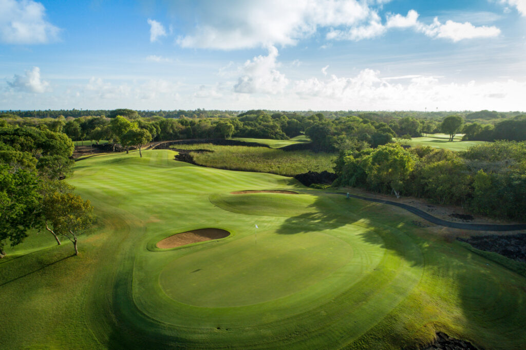 Hole with white flag and bunker at The Links Golf Course with trees around