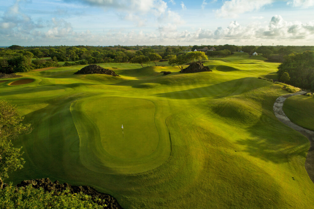 Hole with white flag atThe Links Golf Course with trees around