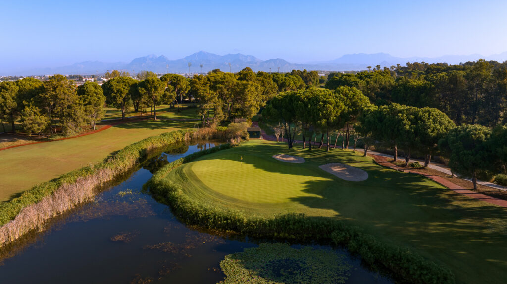 Hole with lake and trees around at The National Golf Course