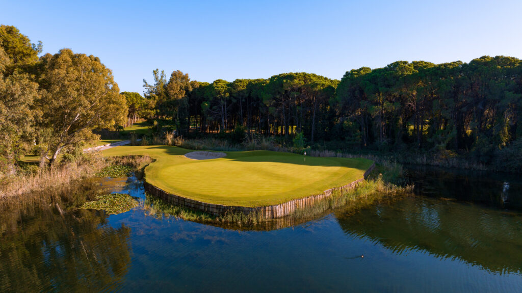 Hole with lake and trees around at The National Golf Course