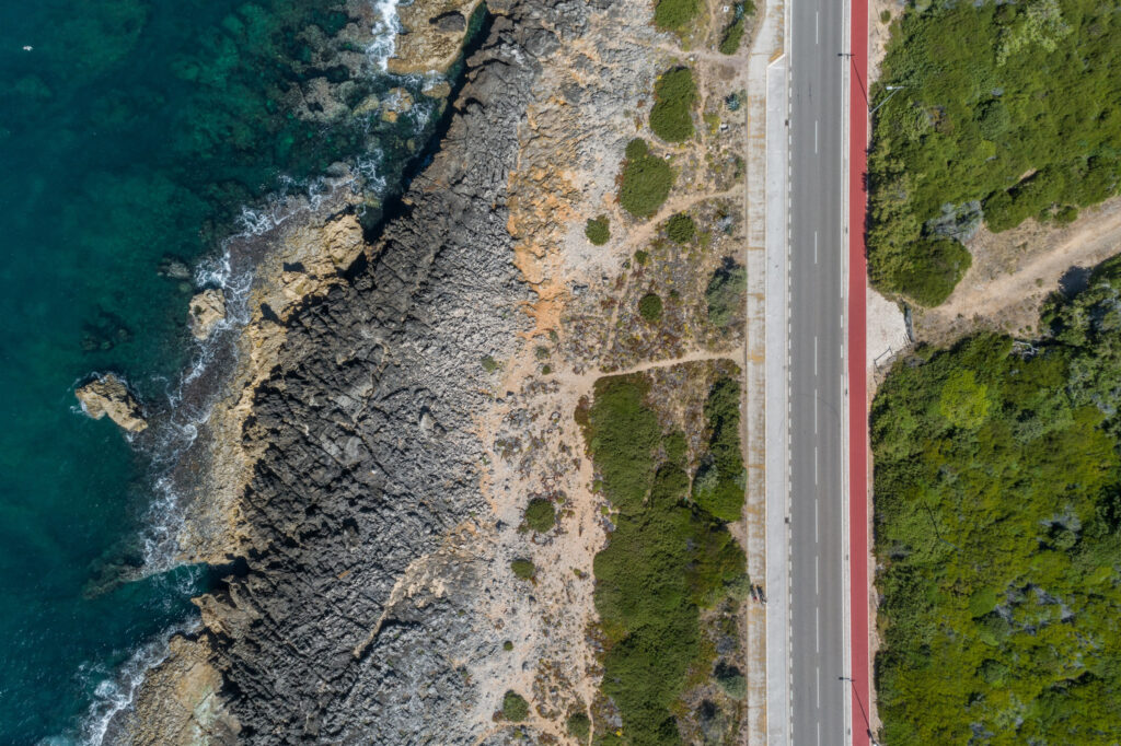 Aerial view of the beach and road at The Oitavos Hotel