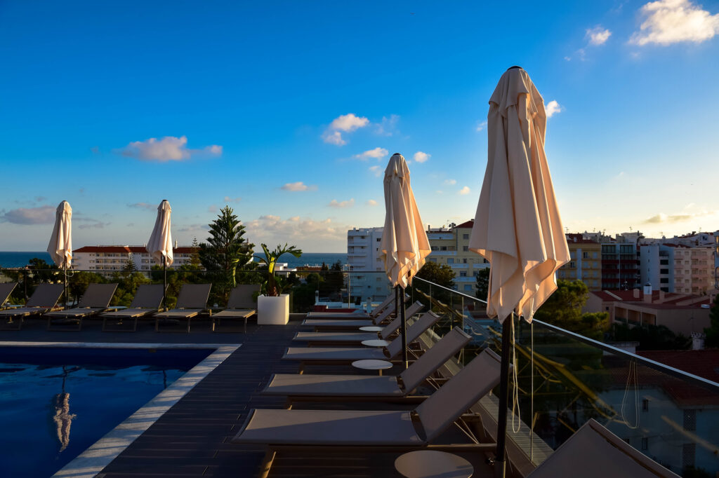 Sun loungers by the outdoor pool at The Prime Energize Monte Gordo