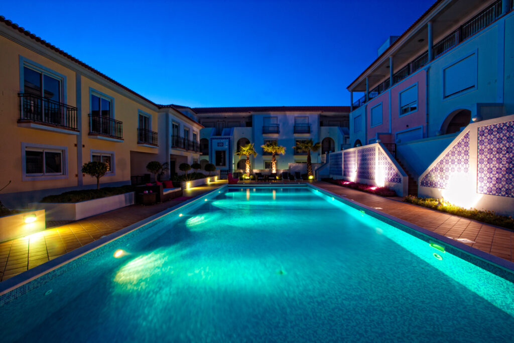 Outdoor pool at Praia d’el Rey - The Village Resort at night