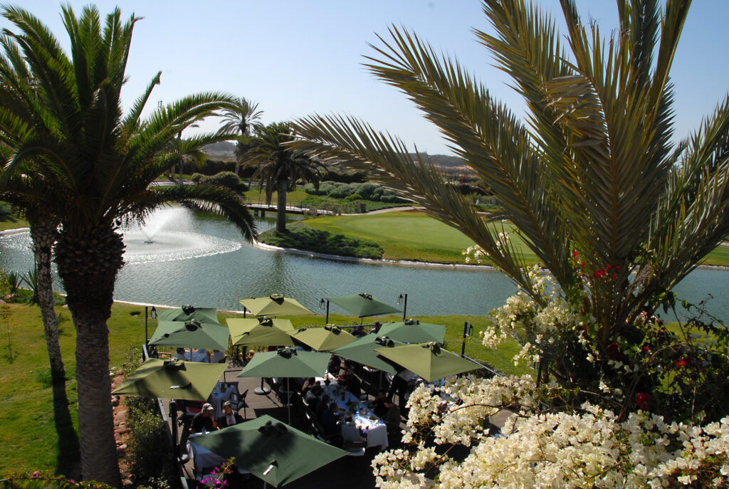 Outdoor dining at Tikida Golf Palace with lake view