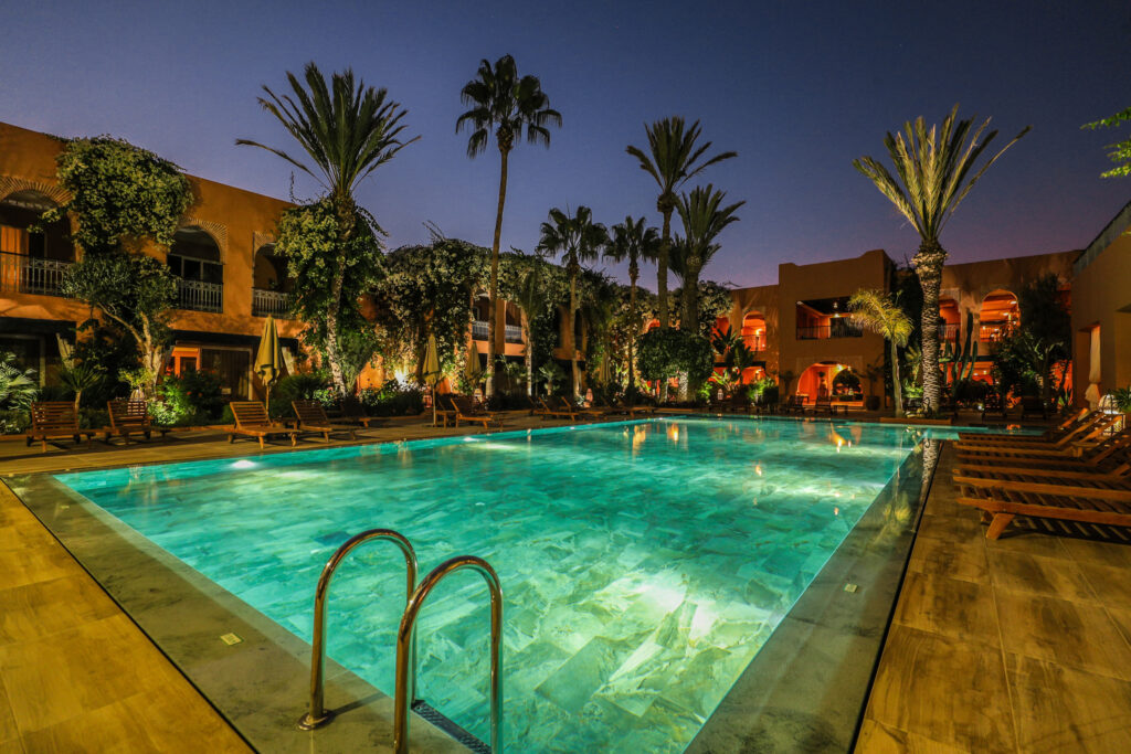 Outdoor pool at Tikida Golf Palace lit up at night