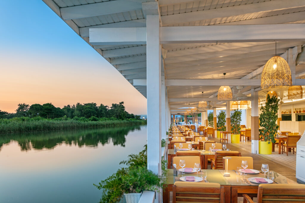 Outdoor dining at Titanic Deluxe Golf Belek Hotel with lake view