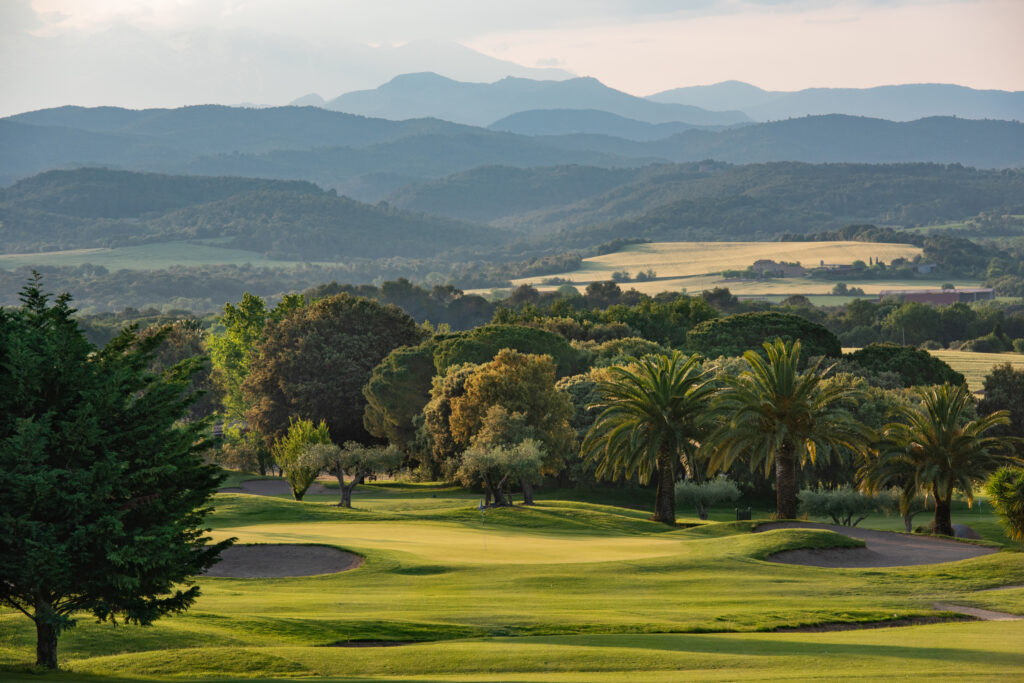 The fairway at Torremirona Golf Course with trees and bunkers in the background