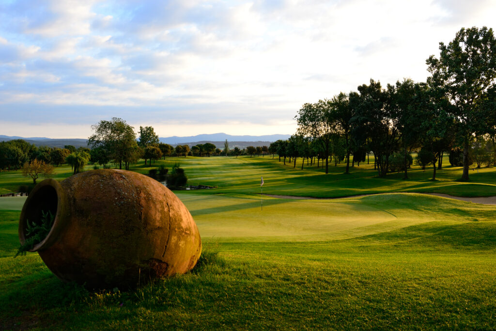 A hole with a large urn in the foreground at Torremirona Golf Course