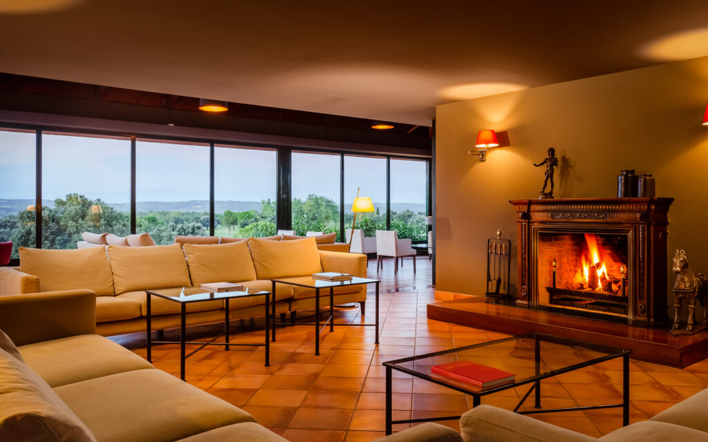 Indoor seating by a fireplace at Torremirona Golf & Spa Resort