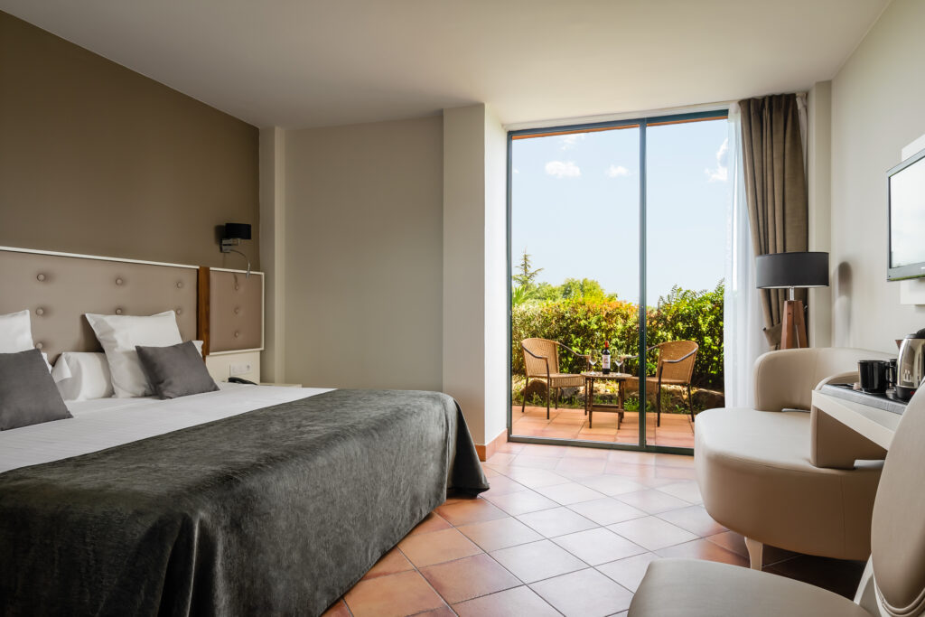 Double bed accommodation with private patio at Torremirona Golf & Spa Resort