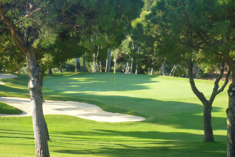 Hole with bunker and trees around at Torrequebrada Golf Course