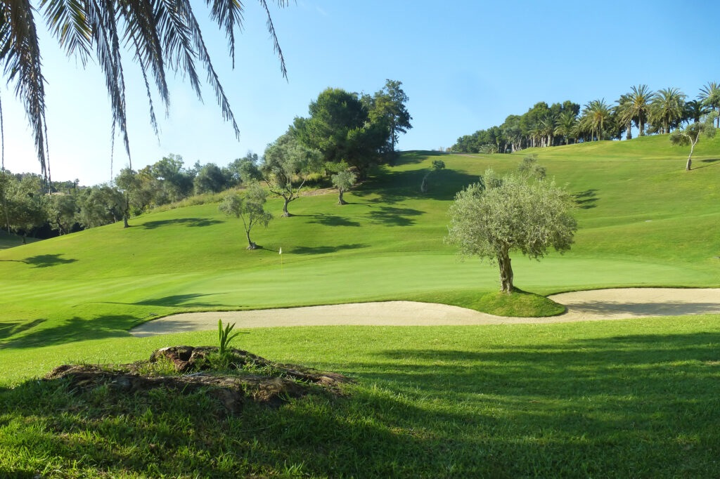 Hole with bunker and trees around at Torrequebrada Golf Course