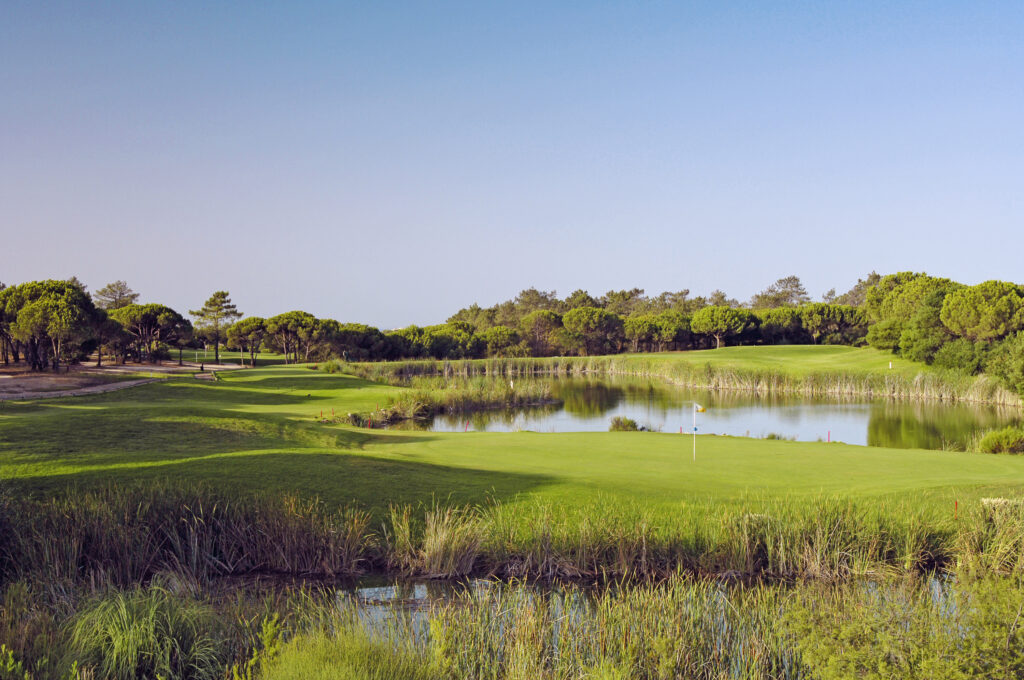 Hole with lake and trees around at Vale do Lobo Royal Golf Course