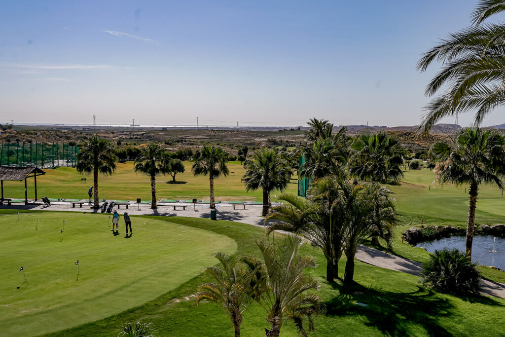 People practicing at the Valle Del Este Golf Course practice facilities