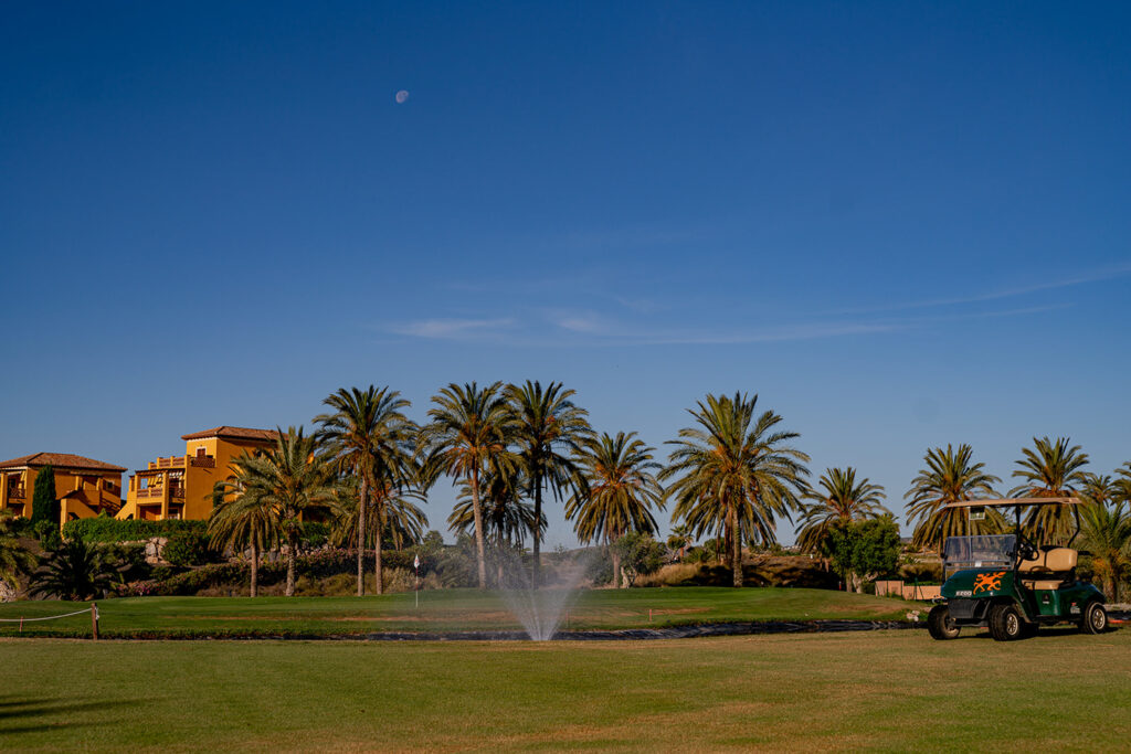 Buggy on fairway with sprinkler on at Valle Del Este Golf Course