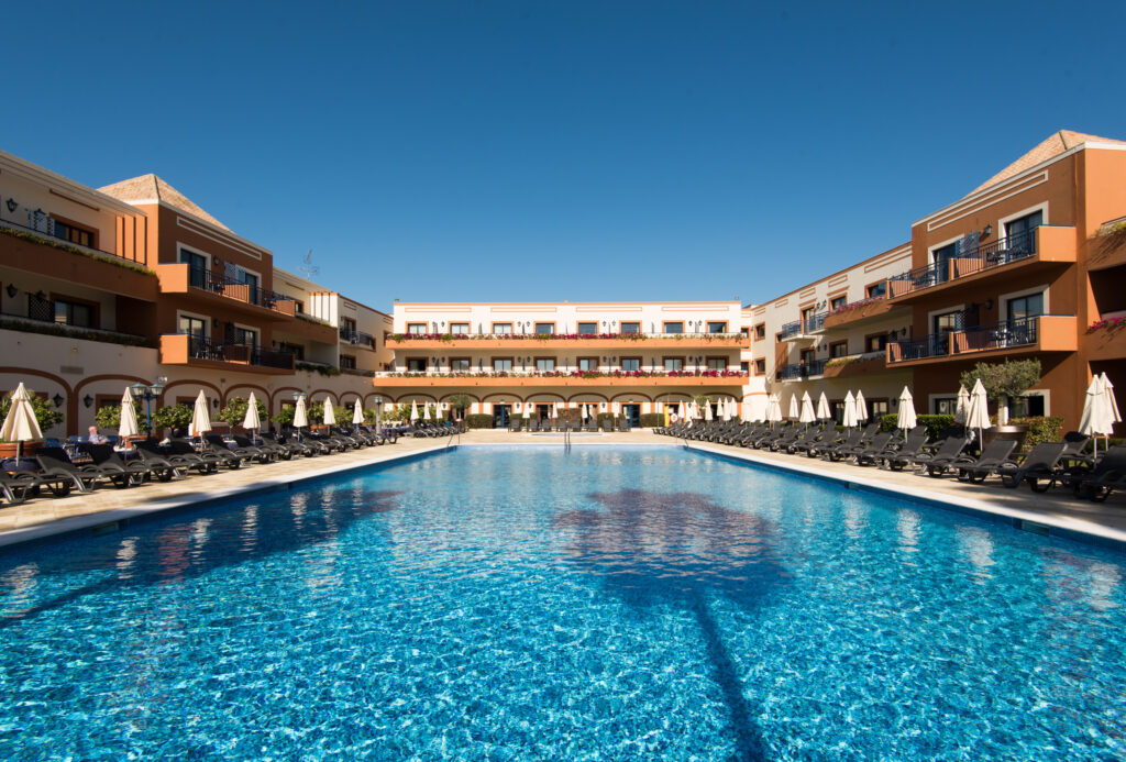 Outdoor pool with sun loungers at Vila Gale Tavira