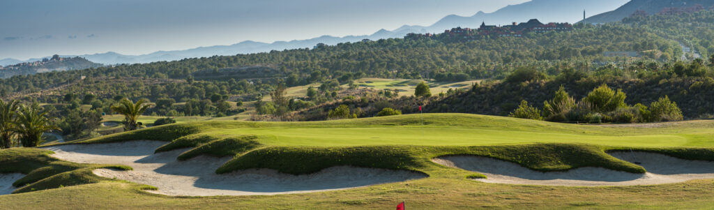 A hole with red flag and bunkers around at Villaitana - Poniente Course