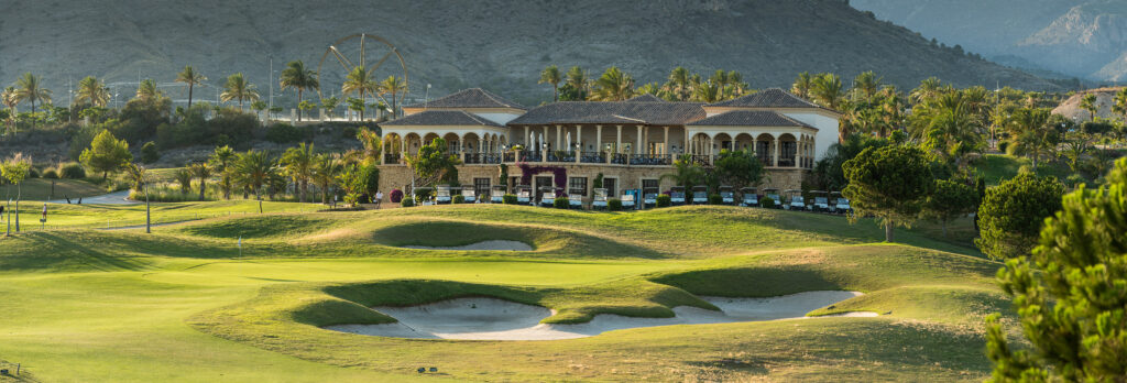 Bunkers on fairway with buildings in background at Villaitana - Poniente Course