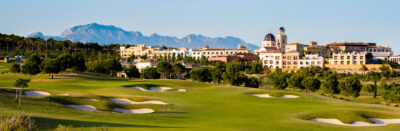 Bunkers on fairway with buildings in background at Villaitana - Poniente Course