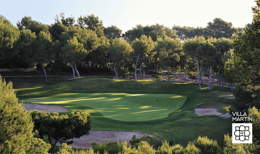 Aerial view of a hole with a red flag at Villamartin Golf Course