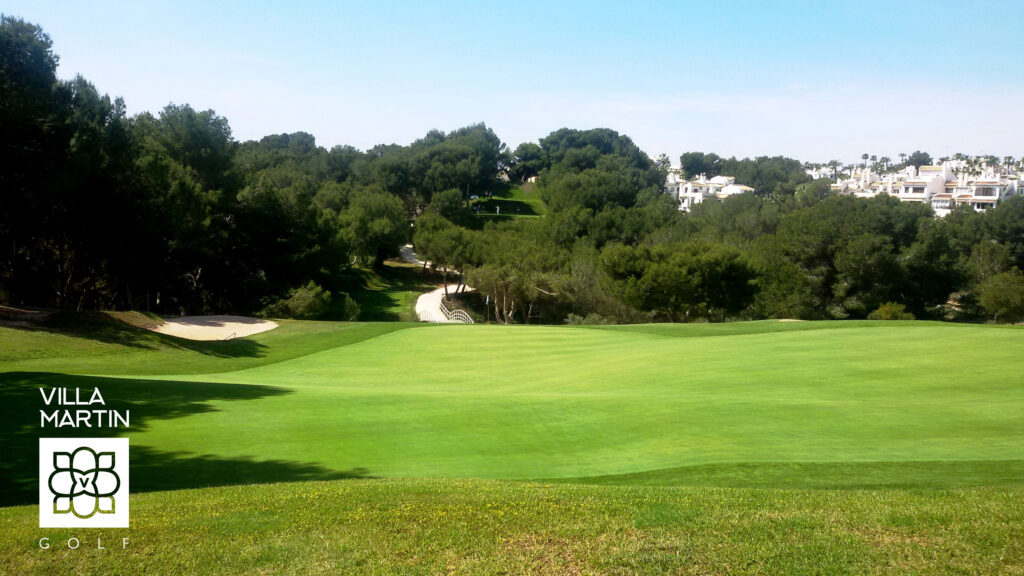 A green with a bunker at Villamartin Golf Course