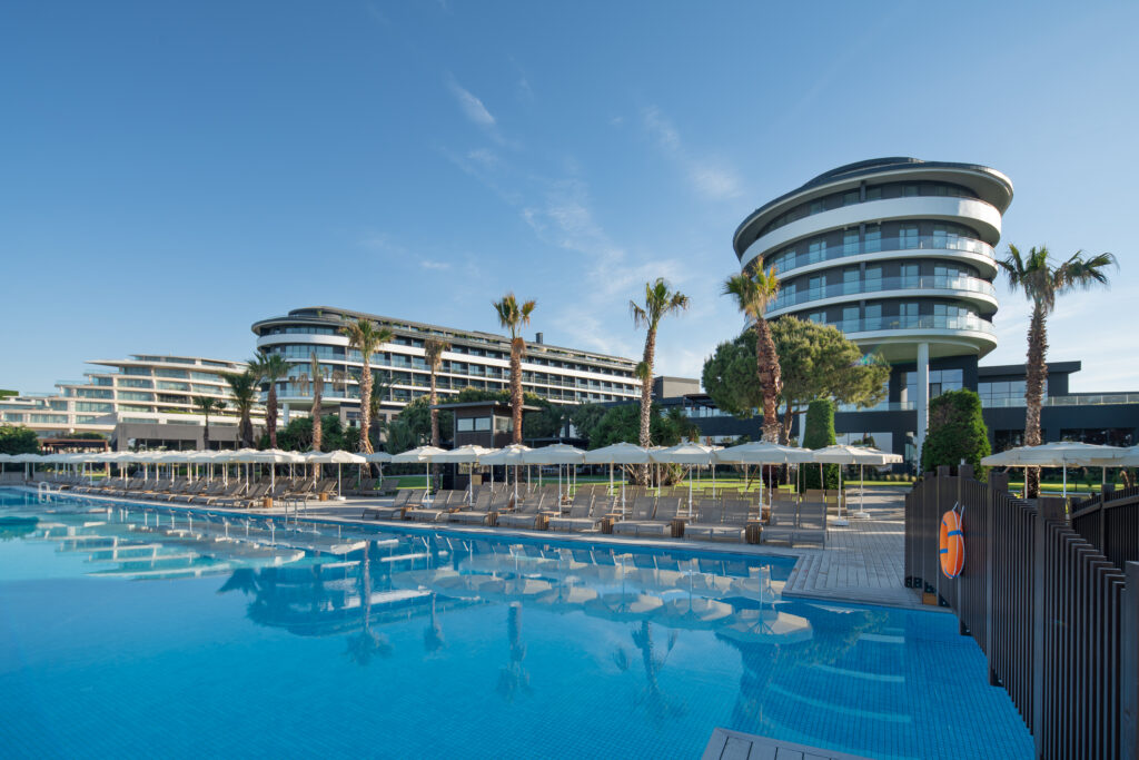 Outdoor pool with loungers at Voyage Belek Golf & Spa