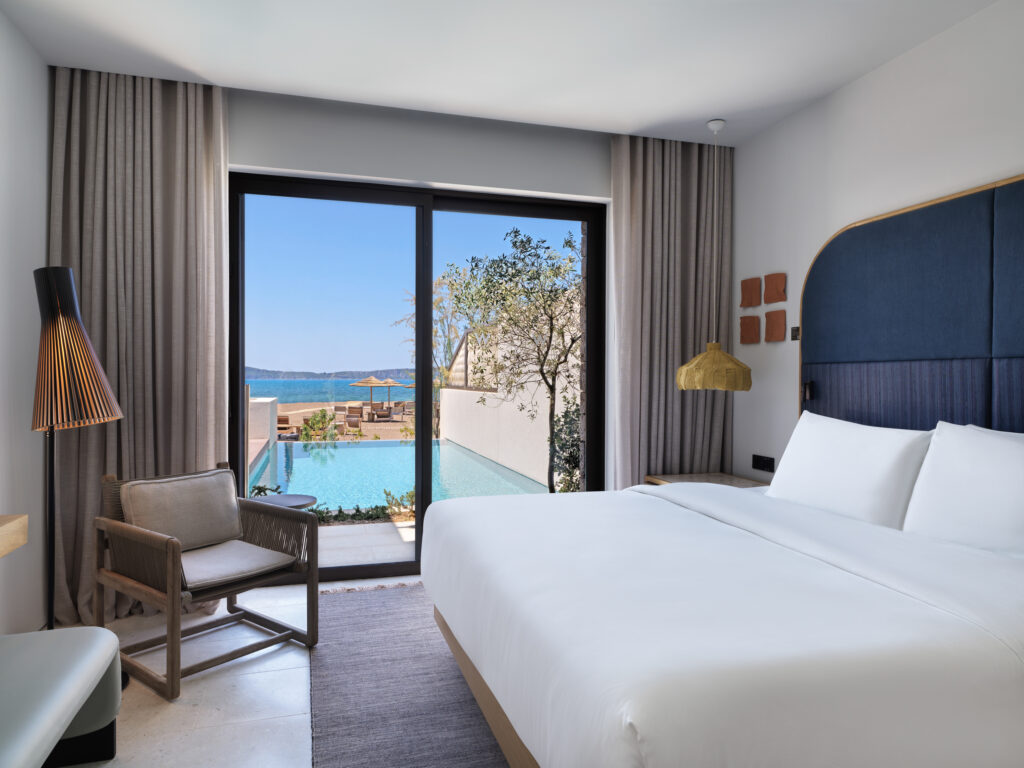 Double bed accommodation with doors leading to pool at W Costa Navarino