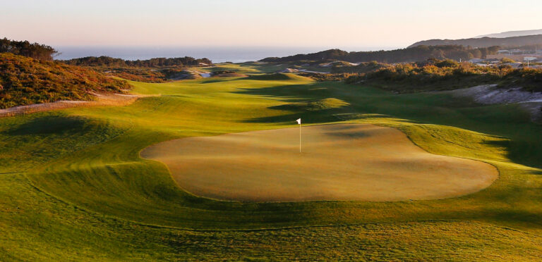 A hole with a white flag at West Cliffs Golf Links